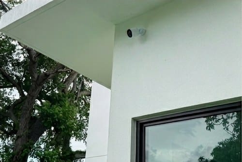 Security camera installed under the eave of a South Florida home with no visible cabling